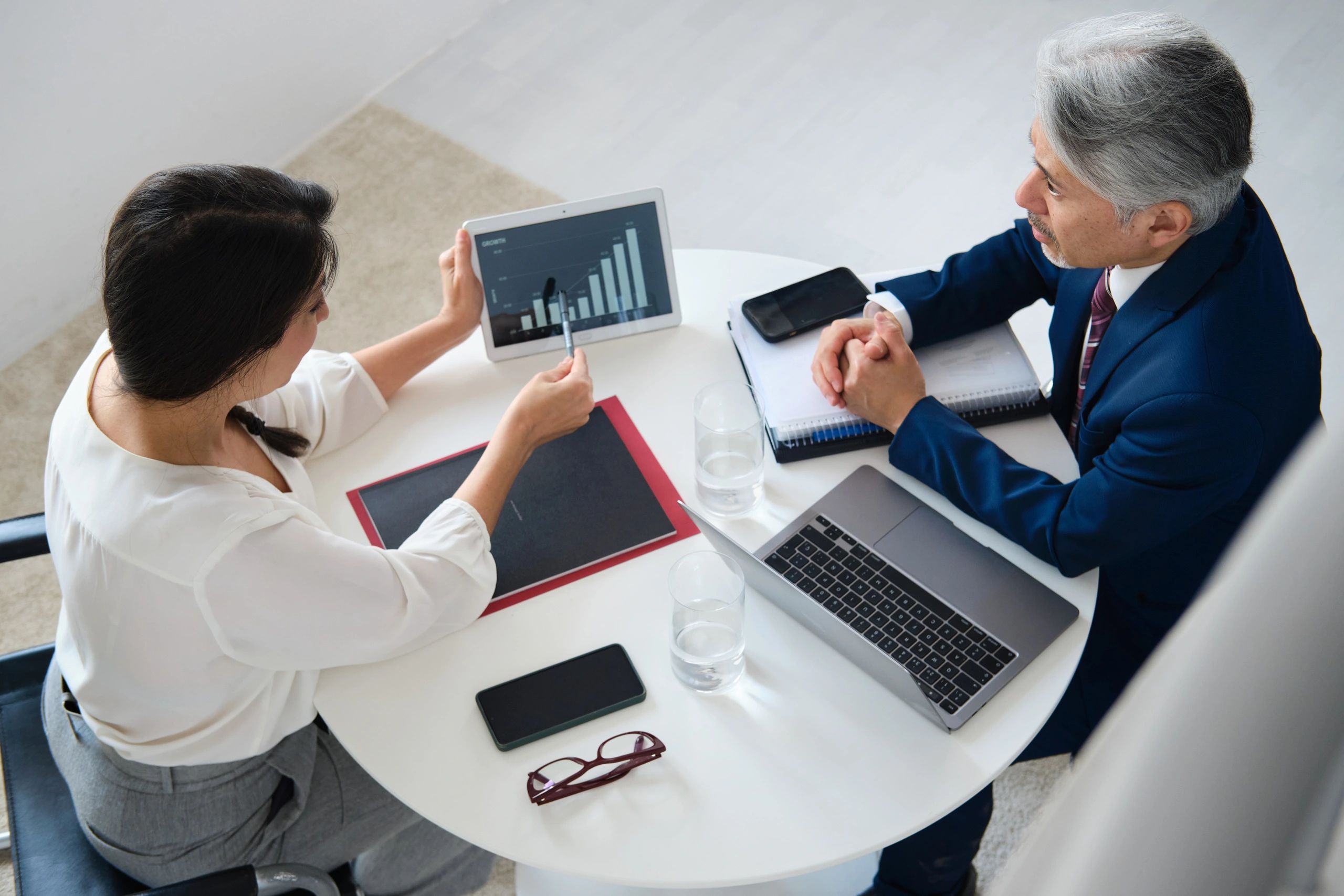 Two professionals discussing financial strategy in a meeting